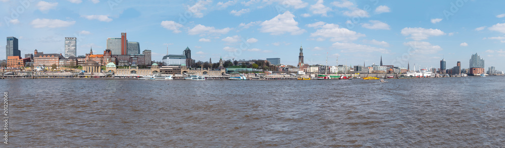 Naklejka premium Hamburg horbor waterfront cityscape with Elbe river and St. Pauli Piers on sunny day