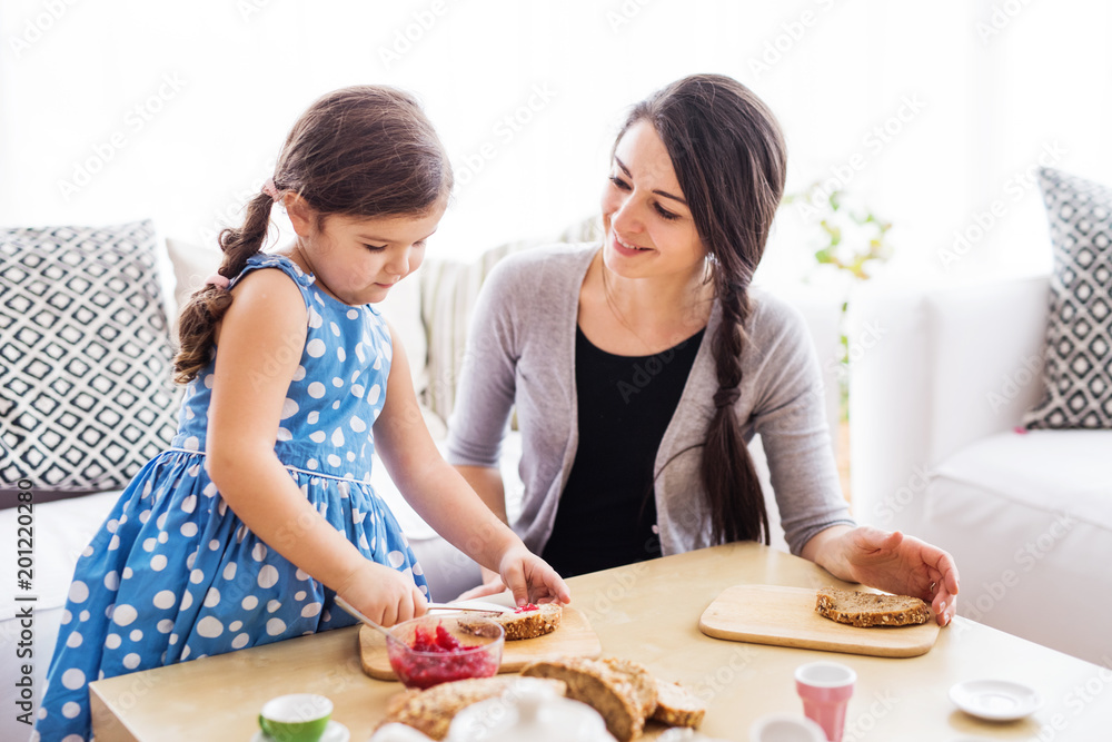 Young mother with a small girl at home. Young mother with a small girl at home.