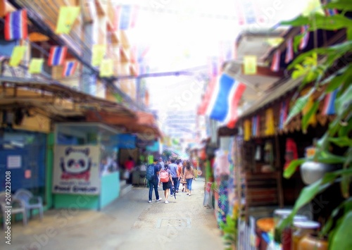 People walking on the street decorated with national flags in Bangkok.