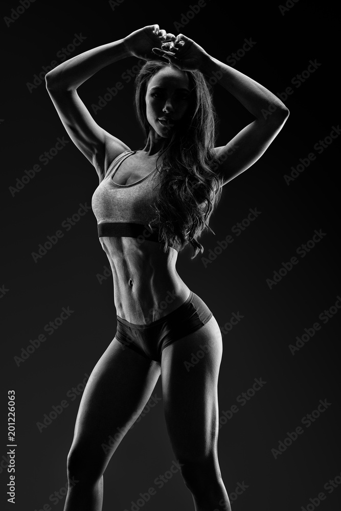 Black and white photo of young perfect shape woman in sports clothing after workout Clipping path Mockup
