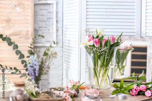 Decorator's workplace with beautiful flowers on table