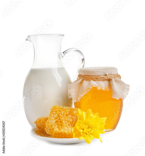 Beautiful composition with milk and honey on white background