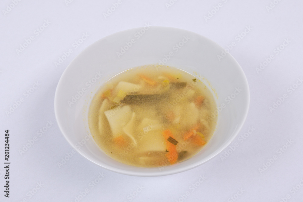 Noodle soup with vegetables on a white Noodle soup with vegetables on a white