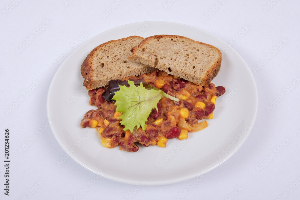 Cowboy beans with bread on a white