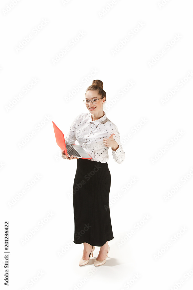 Full length portrait of a smiling female teacher holding a laptop isolated against white background Full length portrait of a smiling female teacher holding a laptop isolated against white background