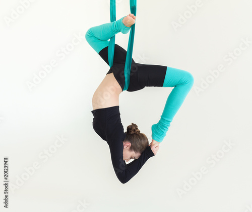 Canvastavla Woman practicing fly yoga over white background