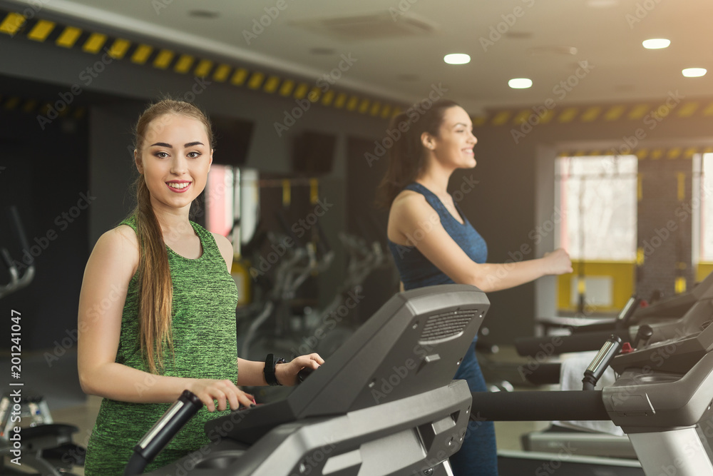 Attractive woman on treadmill in fitness club Attractive woman on treadmill in fitness club
