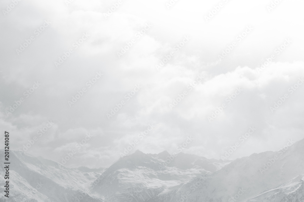 Obraz premium Snow cloud mountain landscape. Snow-capped peaks in the fog