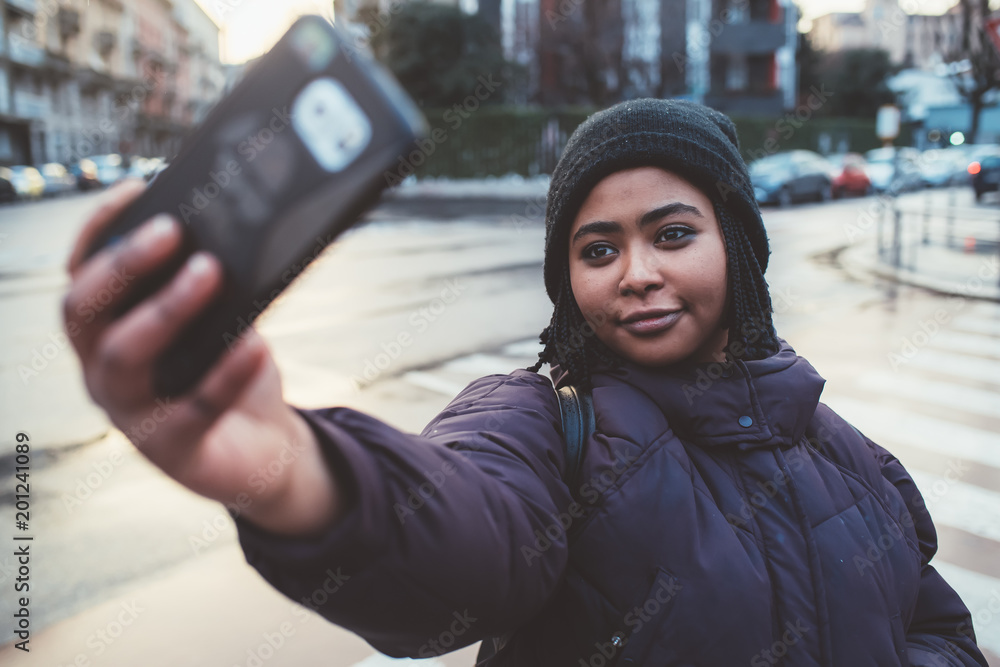 young black woman taking selfie young black woman taking selfie