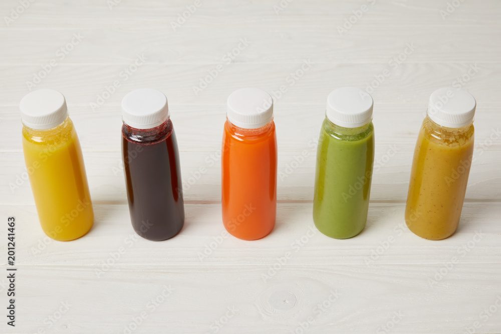 fresh organic smoothies in bottles standing in row on white fresh organic smoothies in bottles standing in row on white