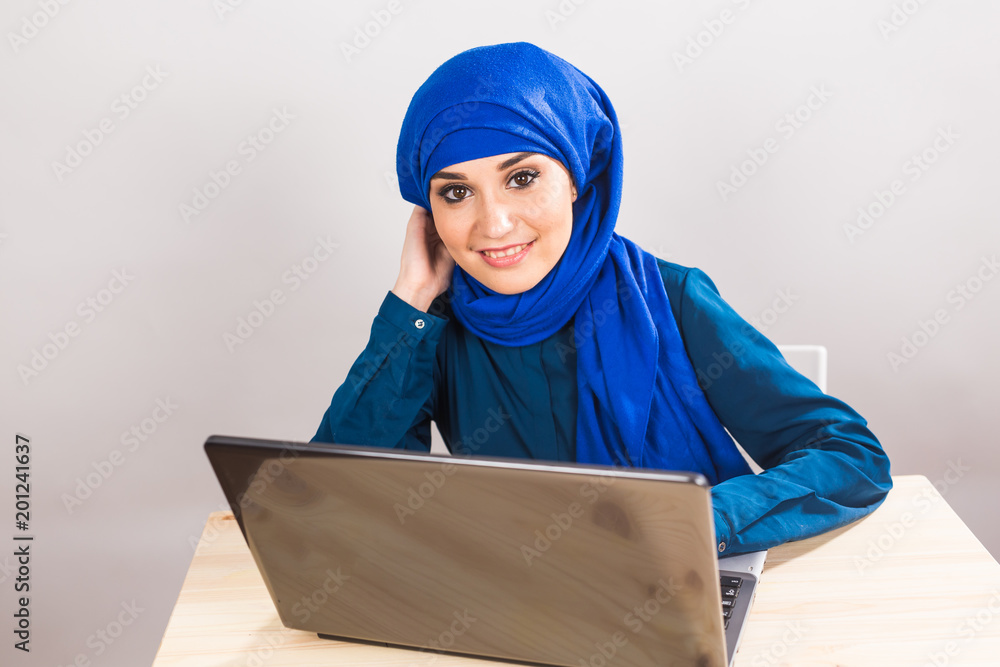 asian muslim woman working with computer. asian muslim woman working with computer.