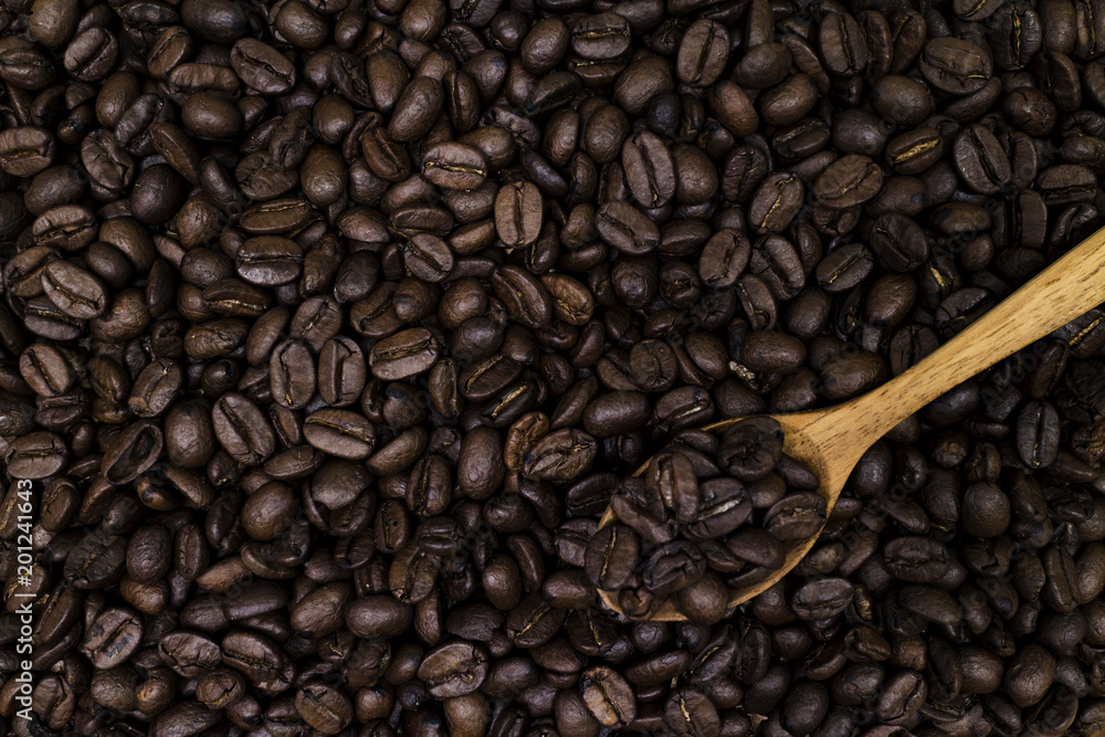 Fototapeta premium coffee bean background with wooden spoon