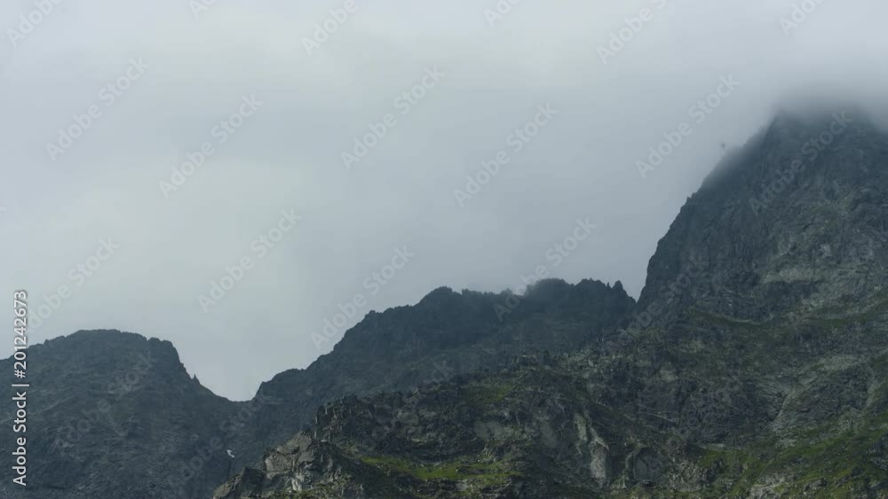 Timelaps of mountain peaks lit between the clouds 4k HDR H264 Timelaps of mountain peaks lit between the clouds 4k HDR H264