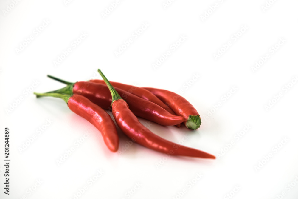 Group of red hot chili peppers isolated on the white background. Selective focus.