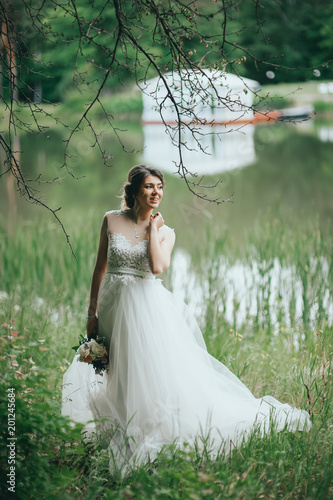 Elegant gentle stylish groom and bride near river or lake. Wedding couple in love photo