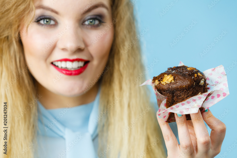 Attractive woman holds cake in hand Attractive woman holds cake in hand