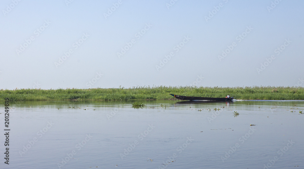 A longboat moves up the White Nile River in South Sudan.