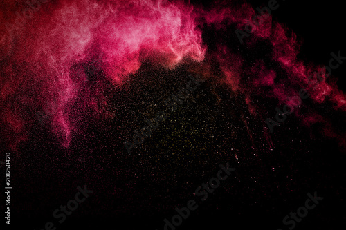 abstract red powder explosion on black background. abstract red dust splattered on background. Freeze motion of red powder splashing.