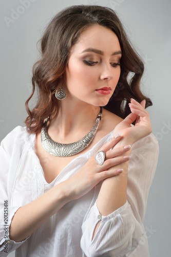 luxury jewelry and fashion concept. A model with earrings necklace and ring on white background