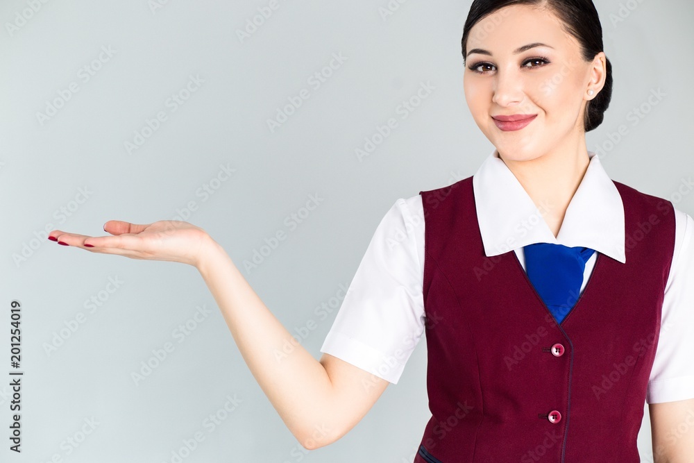 Flight attendant in a red vest gesticulates hands Flight attendant in a red vest gesticulates hands
