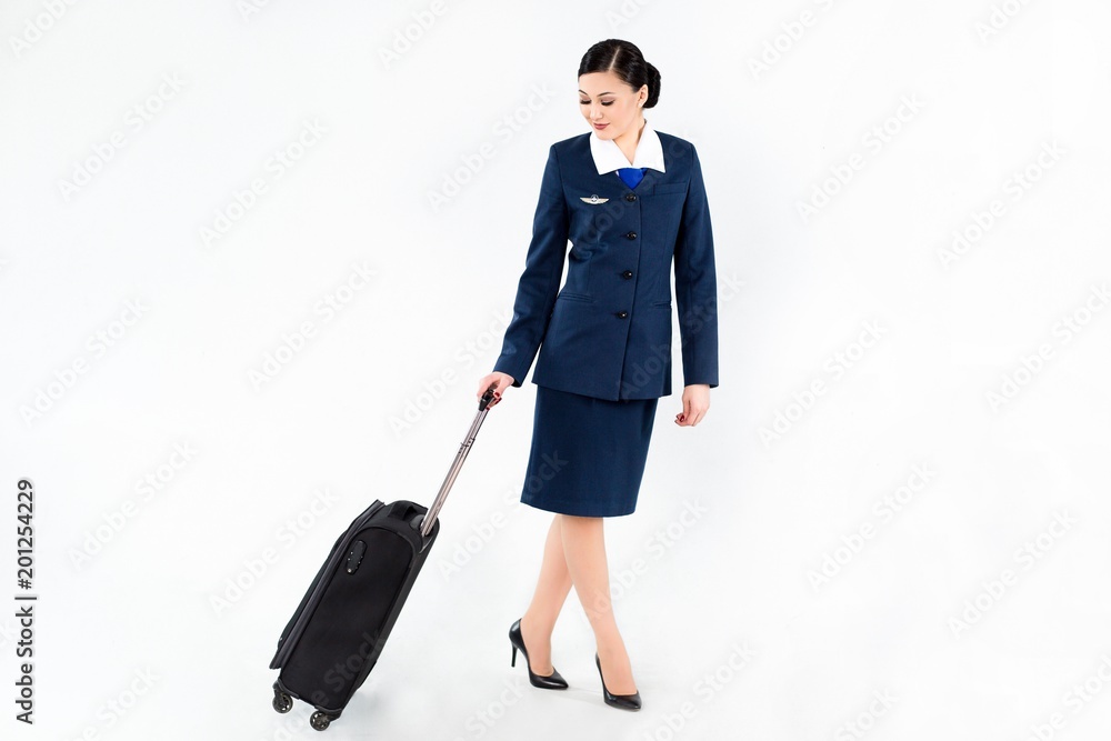 Flight attendant in blue uniform with travel suitcase Flight attendant in blue uniform with travel suitcase