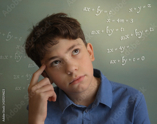 teenager student boy calculating thinking on math equation close up photo photo