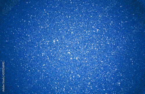 Blue vignetted texture background with white specks