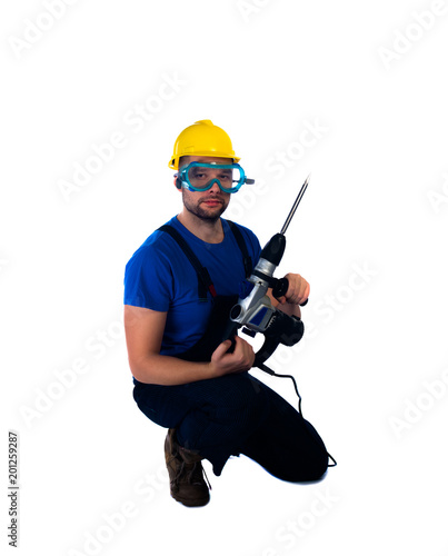 Young workman kneeling on white background photo