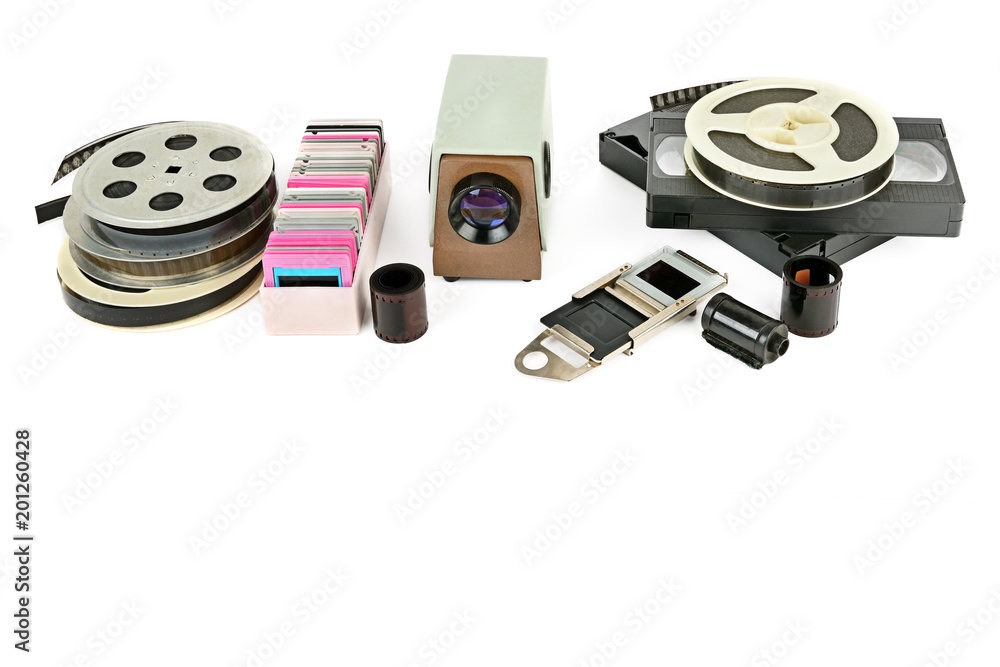 Fototapeta premium Old videocassettes and video projector with slides isolated on white background.