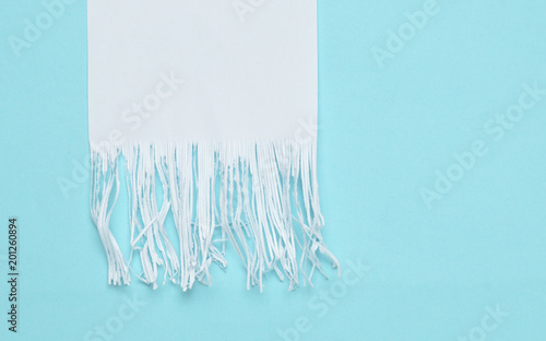Shredded paper strips on a blue pastel background. Minimalist trend. Top view..