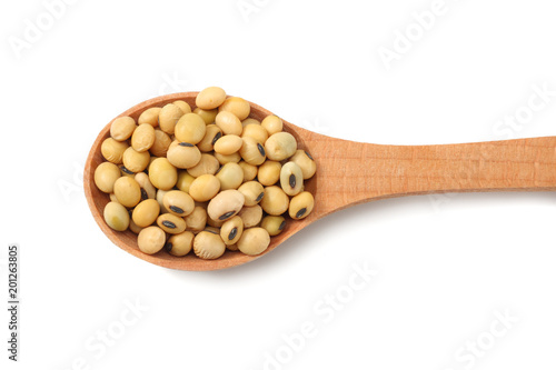 Soybeans in wooden spoon isolated on white background. top view