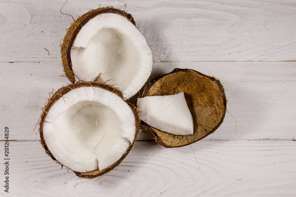 Fresh ripe coconut on white wooden table Fresh ripe coconut on white wooden table