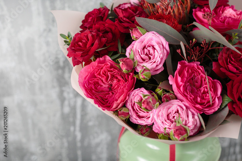 Close-up Beautiful Bouquet. Spring flowers on gray background. flower shop. Wooden table