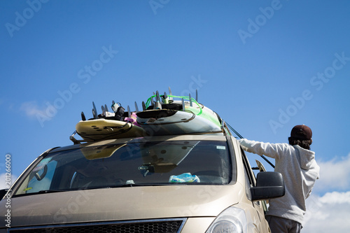 Surfboards mounted on the roof of the car. photo travel. Leisure