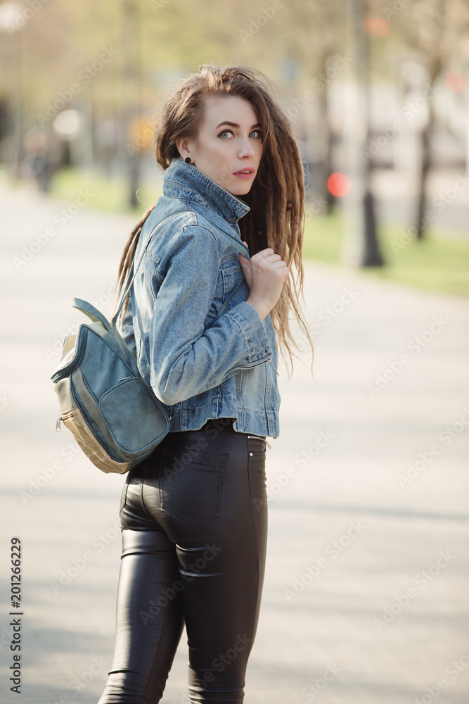 Portrait of fashionable woman with dreadlocks keep bag