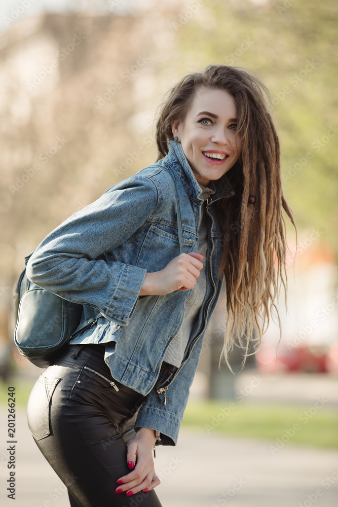 Portrait of fashionable woman with dreadlocks keep bag Portrait of fashionable woman with dreadlocks keep bag