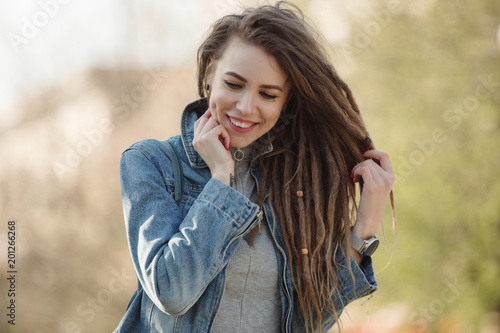 Valokuva Smiling portrait of fashionable woman with dreadlocks