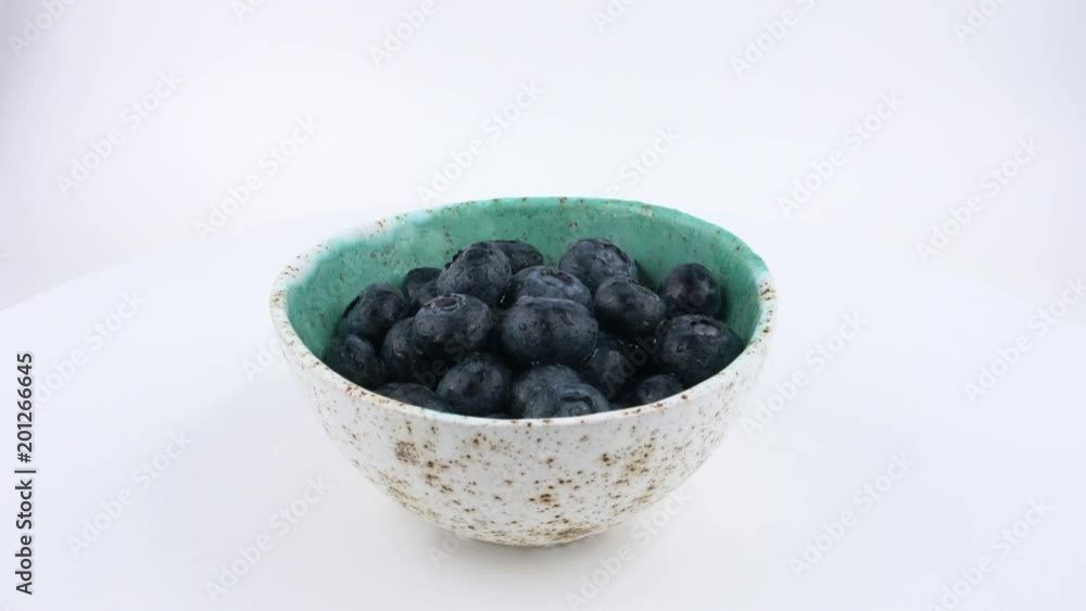 Cup filled with fresh blueberries rotates on a white background. Isolated. Loopable. Close up. Cup filled with fresh blueberries rotates on a white background. Isolated. Loopable. Close up.