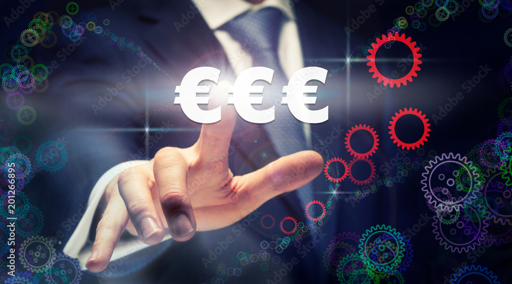 A businessman pressing a Euros business concept on a graphical display of cogs A businessman pressing a Euros business concept on a graphical display of cogs