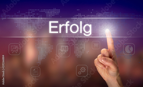 A businessman pressing a Success "Erfolg" button in German on a futuristic computer display