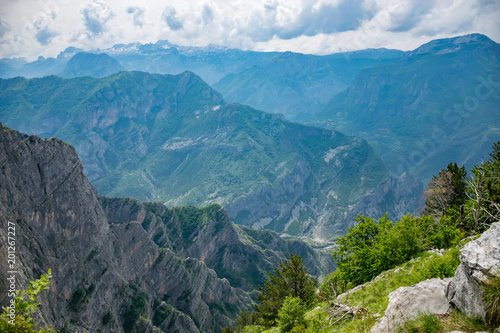 The tops of the picturesque mountains are covered with white snow. photo