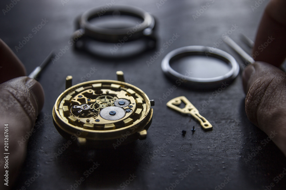 Watchmaker is repairing the mechanical watches in his workshop