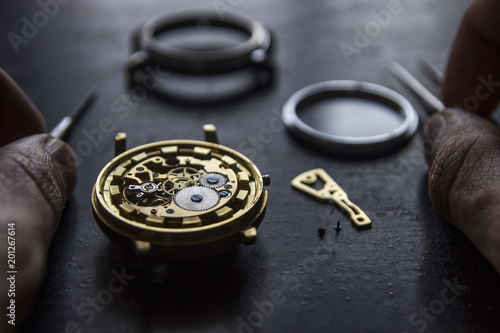 Watchmaker is repairing the mechanical watches in his workshop