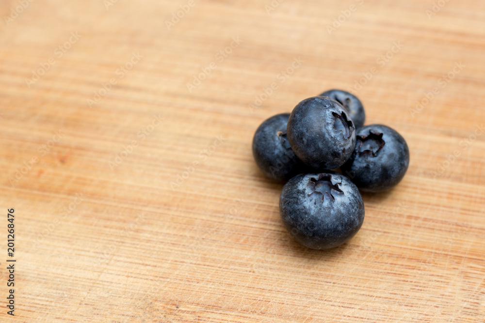 5 Ripe Blueberry close-up on wooden background with open space on one side 5 Ripe Blueberry close-up on wooden background with open space on one side
