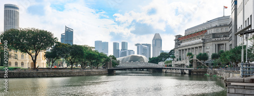 Singapore, panoramic view from river bank to Cavenagh bridge with down-town skyscrapers in background