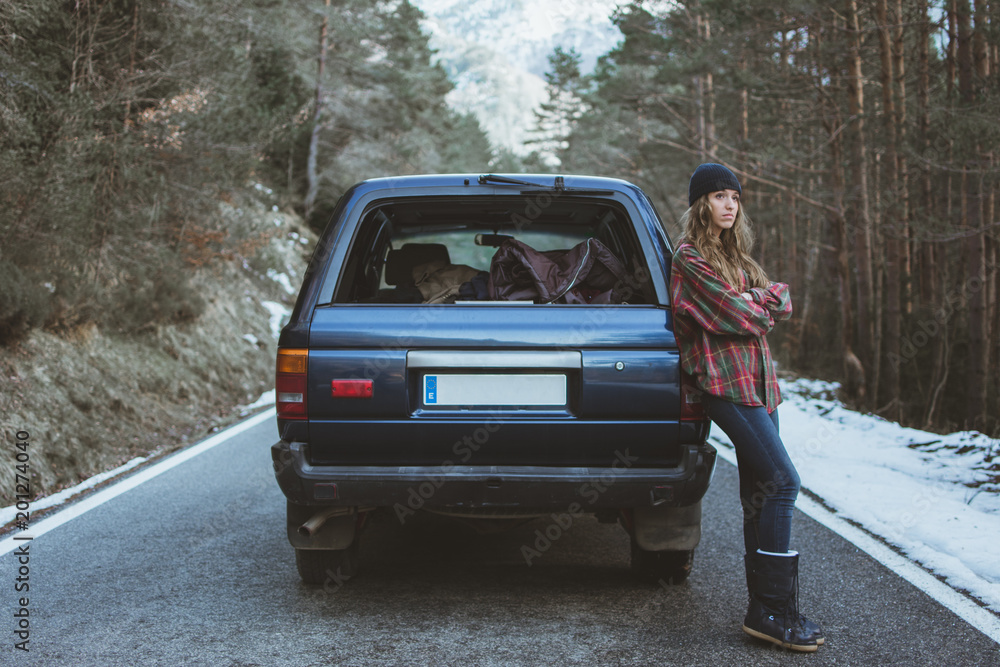 Woman leaning on car
