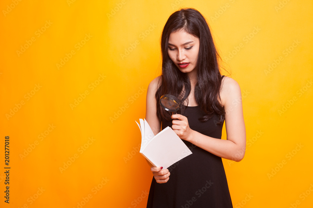 Asian woman with a book and magnifying glass. Asian woman with a book and magnifying glass.