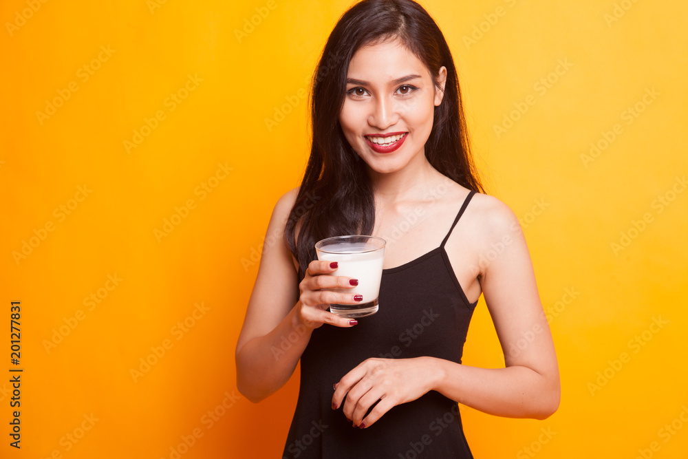 Healthy Asian woman drinking a glass of milk. Healthy Asian woman drinking a glass of milk.