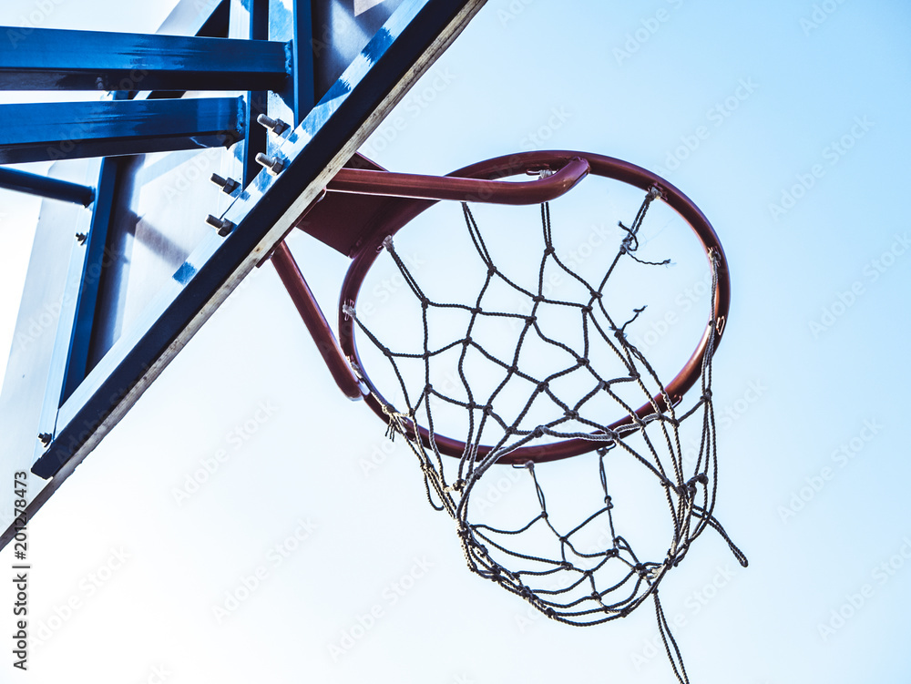 close up basketball basket on a sunny day with blue sky