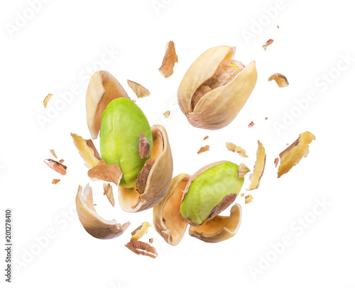 Pistachio crushed in the air close-up isolated on white background photo